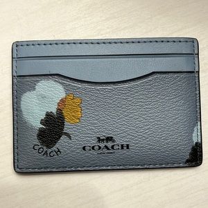 Coach card holder in blue with black, light blue, and gold details.